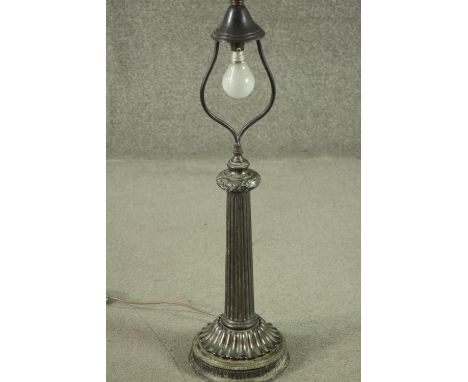 A vintage metal table lamp with ribbon and acorn decoration above a tapering fluted column on acanthus base. Lacks shade. H.8