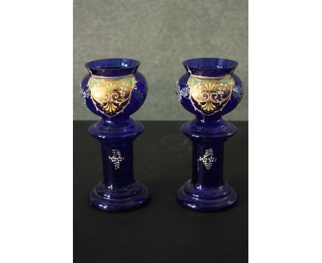 A pair of early 20th century Bohemian Bristol blue glass vases with gilded and enamel foliate and floral design. H.24 Dia. 12