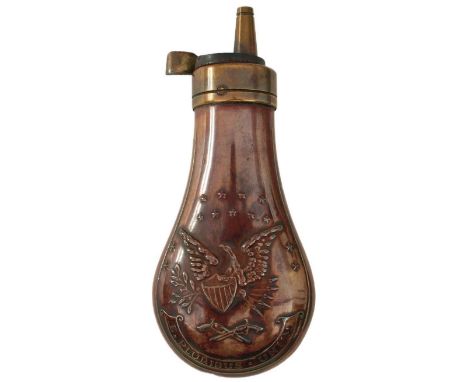 AN EMBOSSED COPPER POWDER FLASK, the lacquered copper body decorated with, stars, an eagle and shield above crossed revolvers