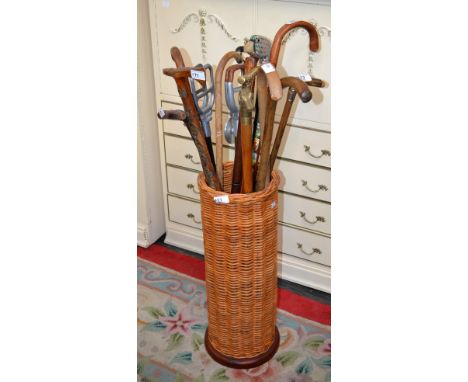 A wickerwork stick stand with assorted sticks (15)