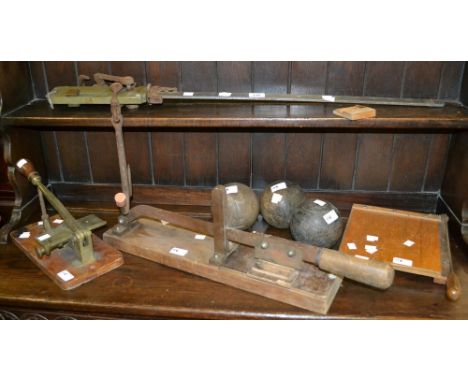 A vintage beam or pig balance; a set of three vintage crown green bowls; a leather worker's notching guillotine by Hampson Be