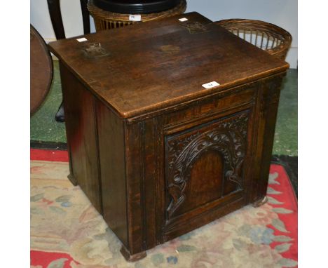 An oak box, hinged top, priory style panel to front 