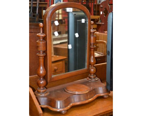 A Victorian mahogany dressing mirror, arched mirror, turned uprights, shaped base with hinged cover to trinket box, circa 186