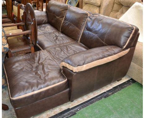 A modern brown leather three seat settee with integral pouffe to on end.