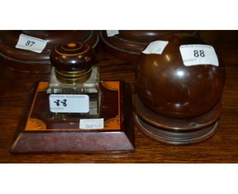 An early 20th century hardwood inkwell, lift-off globular cover, circular base, 10cm high; an Edwardian mahogany and marquetr