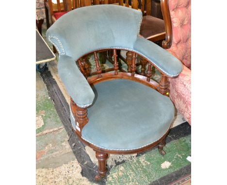 A Victorian mahogany library chair, scrolling back, curved and spindled armrail, circular stuffed overseat, turned forelegs, 