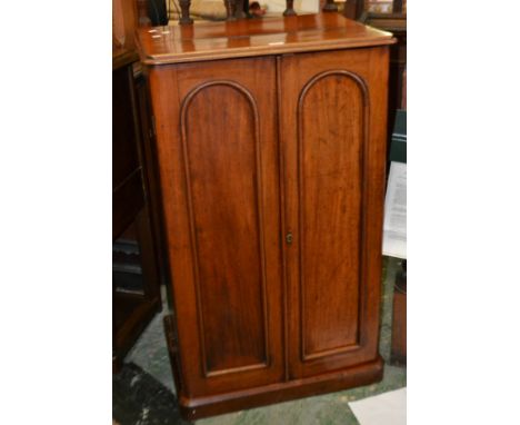 A Victorian mahogany collector's cabinet, moulded top, two arched panel doors enclosing 17 drawers, circa 1880.