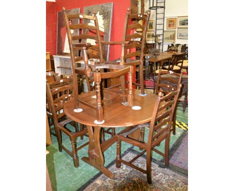 An oak dropleaf table, oval top, lyre end supports; two ladder back carvers; four ladder back chairs (7)