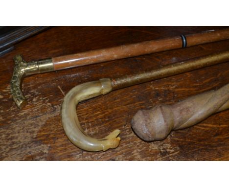 A gentleman's walking cane, horn handle, thistle carved end; a further walking stick, presentation plaque; a cast brass handl