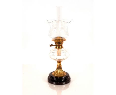 A Victorian oil lamp,&nbsp;having brass column and cut glass reservoir, etched shade and chimney, 60cm high overall