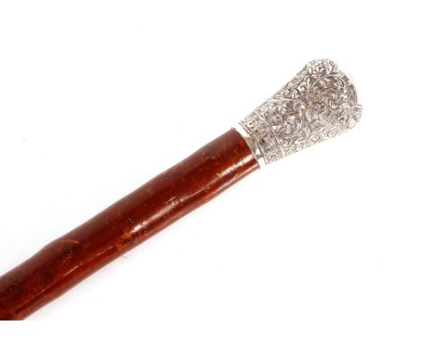 A rustic walking stick,&nbsp;the Indian white metal knop handle profusely foliate decorated, 92.5cm long