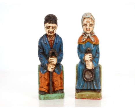 Two painted Folk Art type figures, of a seated lady with a ladle and a gentleman with walking stick, 32cm high