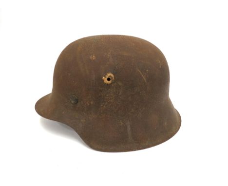 A Third Reich era German M42 helmet, no decals, markings unclear, liner mainly intact