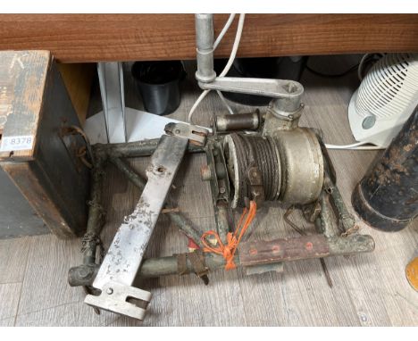 An aircraft bomb hoist thought to be from a Consolidated B-24 Liberator bomber, together with a Type AN B-10 bomb shackle / r
