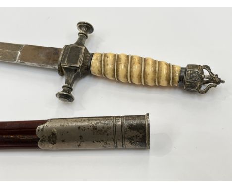 An Imperial German style dagger, ivorine grip, crown pommel, cross-hilt and an acid-etched blade, housed within a steel mount