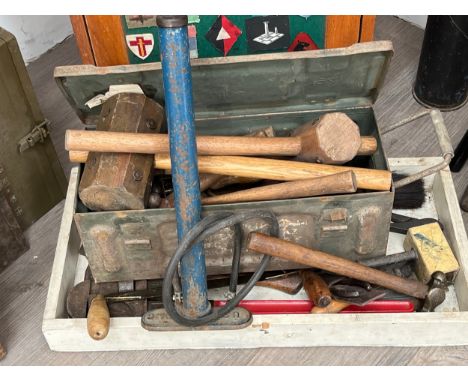 A collection of tools, some with wartime dates, including mallets, hammers and a US tyre pump
