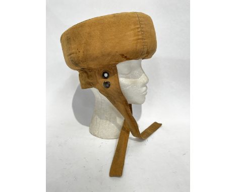 A scarce WWII British Parachute Training Bungee Helmet, cloth covered with stuffing to the band. Original tie straps and neck
