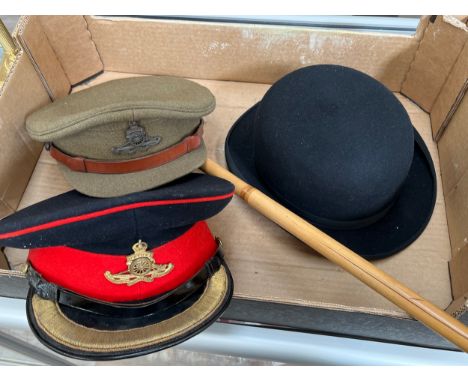 A Royal Artillery parade peaked cap, a Royal Artillery khaki service dress cap (both with King's crown badges), a bamboo swag