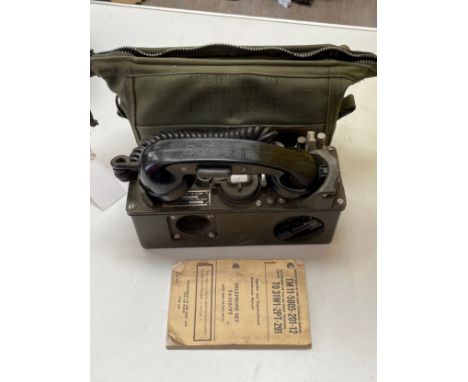 A Vietnam era field telephone in original case with instruction book