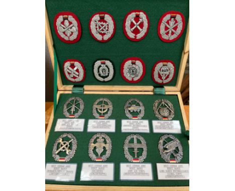 Two cases of mixed West German insignia including Beret badges