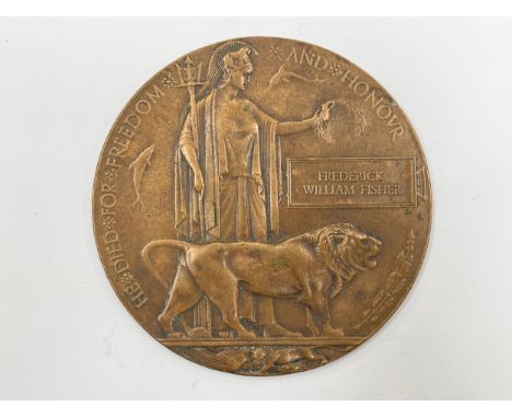 A WWI Memorial Plaque / Death Penny in bronze, named to FREDERICK WILLIAM FISHER, one of three servicemen with the same name 