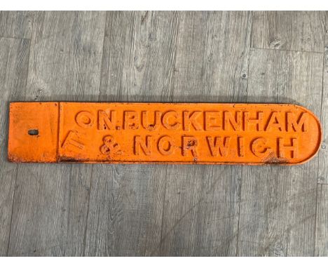 A vintage road sign TO N. BUCKENHAM &amp; NORWICH, double sided, cast iron painted in orange, possibly wartime