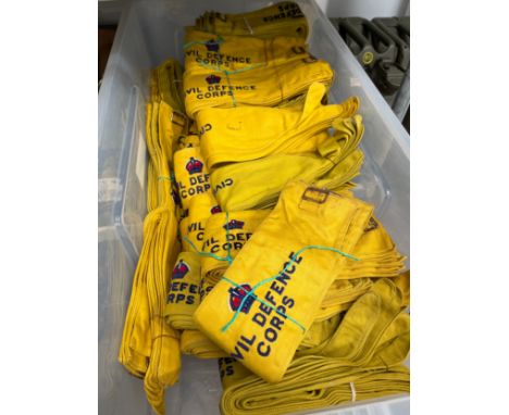 A box of post-war Civil defence Corps armbands, King's Crown, together with a post-war Civil Defence Corps rainproof coat