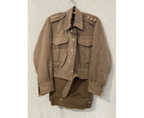 A WWII battledress blouse, Warmstrong Mfg. Pty. Ltd., size 14, dated 1941, with three pips denoting captain, possible repair 