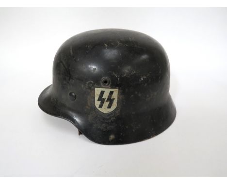 A German M40 pattern helmet with SS decal to left side  and Nazi emblem to right (unlike most examples), black painted with E