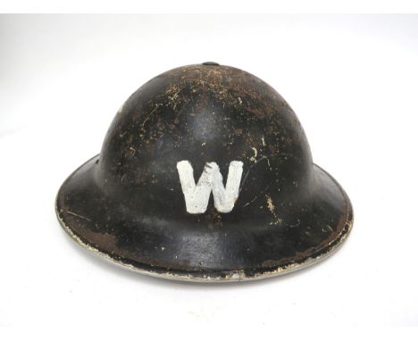 A WWII British Brodie helmet, black painted with W painted denoting warden, shell and liner dated 1939, with chinstrap and pa
