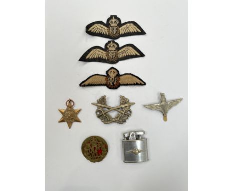 A quantity of insignia including RAF wing insignia, lighter with applied badge and Africa Star Medal etc