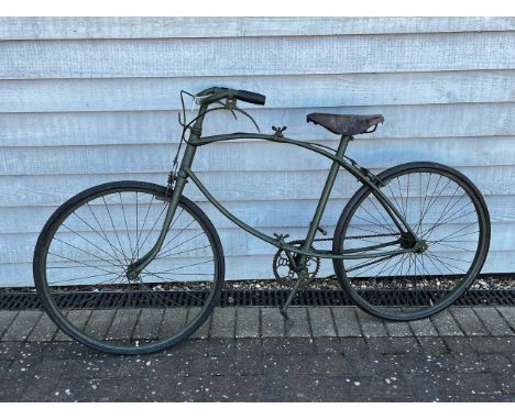 A BSA folding paratrooper / airborne forces bicycle, green painted frame with brown leather saddle. These bikes were famously