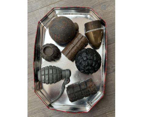 A collection of inert grenades and shell parts including M1913 German frag grenade body