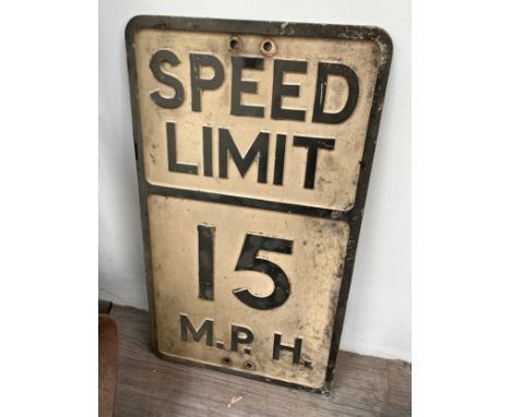 A vintage 'SPEED LIMIT 15 MPH' cast metal sign, thought to be ex military base
