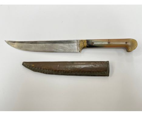 An early 20th Century sheath knife, twin fuller blade joining a horn grip, brass scabbard