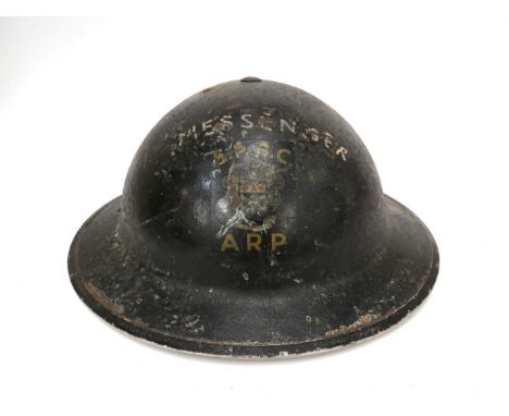 A WWII British ARP Messenger helmet, blackened steel with MESSENGER lettering over SPBC ARP coat of arms (denoting St. Pancra