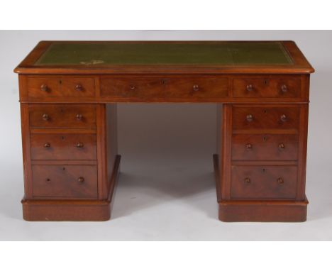 A Victorian mahogany twin pedestal writing desk, having gilt tooled leather inset writing surface above an arrangement of nin