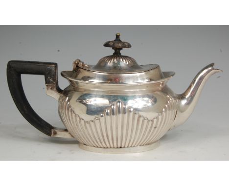 A Mappin & Webb silver bachelors teapot, of half-reeded oval form, the hinged cover with engraved armorial, 14.4oz, Sheffield