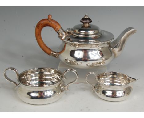 An Edwardian silver three piece bachelors teaset, comprising; teapot, twin handled sugar and cream, each of squat circular fo
