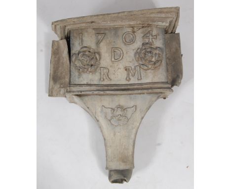 An 18th century lead water hopper, decorated with two flowerheads and a cherub mask, monogrammed DRM and bearing date 1704, h