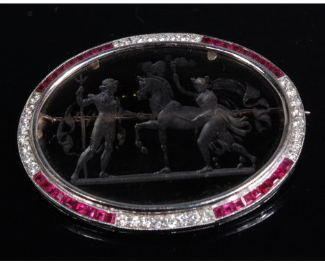 A white metal ruby and diamond set brooch, having a centre rock crystal panel, finely engraved with mythological scene of Nep