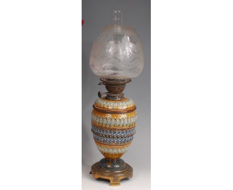 A Doulton Lambeth stoneware pedestal oil lamp, having an acid etched clear shade, the stoneware body with banded decoration i