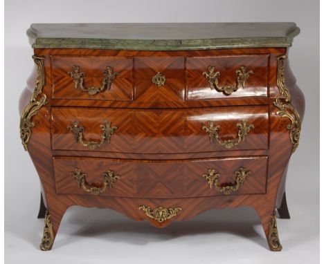 A French walnut and marble topped bombe commode, in the Louis XV style, having cast gilt metal mounts, w.125cm, d.52cm, h.94c