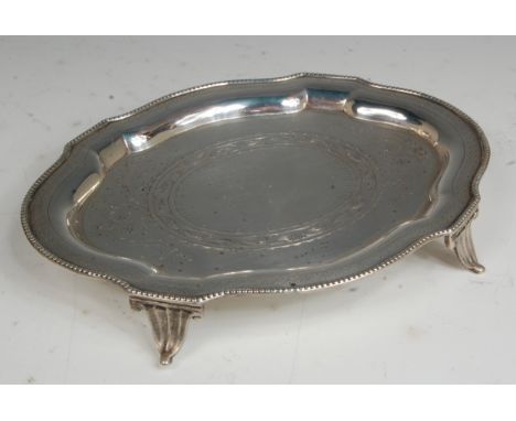 A mid-Victorian silver teapot stand, of shaped oval form and with bright cut engraved decoration, 7.7oz, make Walter & Charle