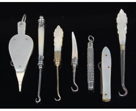 A Victorian mother of pearl and ivory mounted button-hook, in the form of a pair of bellows; together with various silver mou