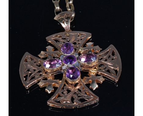 A Victorian yellow metal amethyst set pendant as a Maltese cross, the oval cut amethyst each dispersed with a small rough cut