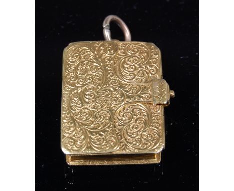A Victorian 18ct gold miniature vesta case, in the form of a book, having all-over foliate engraved decoration, opening to re