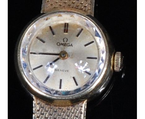 A ladies Omega 14ct gold bracelet watch, having signed circular dial with baton markers, manual wind movement, and meshlink b