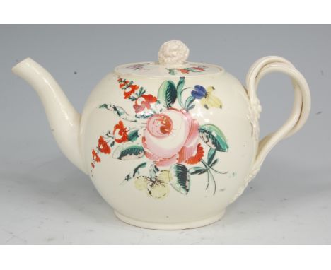 A late 18th century creamware teapot, of bullet shape, the cover with flowerhead finial, the whole polychrome decorated with 