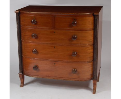 A Regency mahogany bowfront chest, of two short over three long drawers within half-spiral turned pilasters, to sabre support